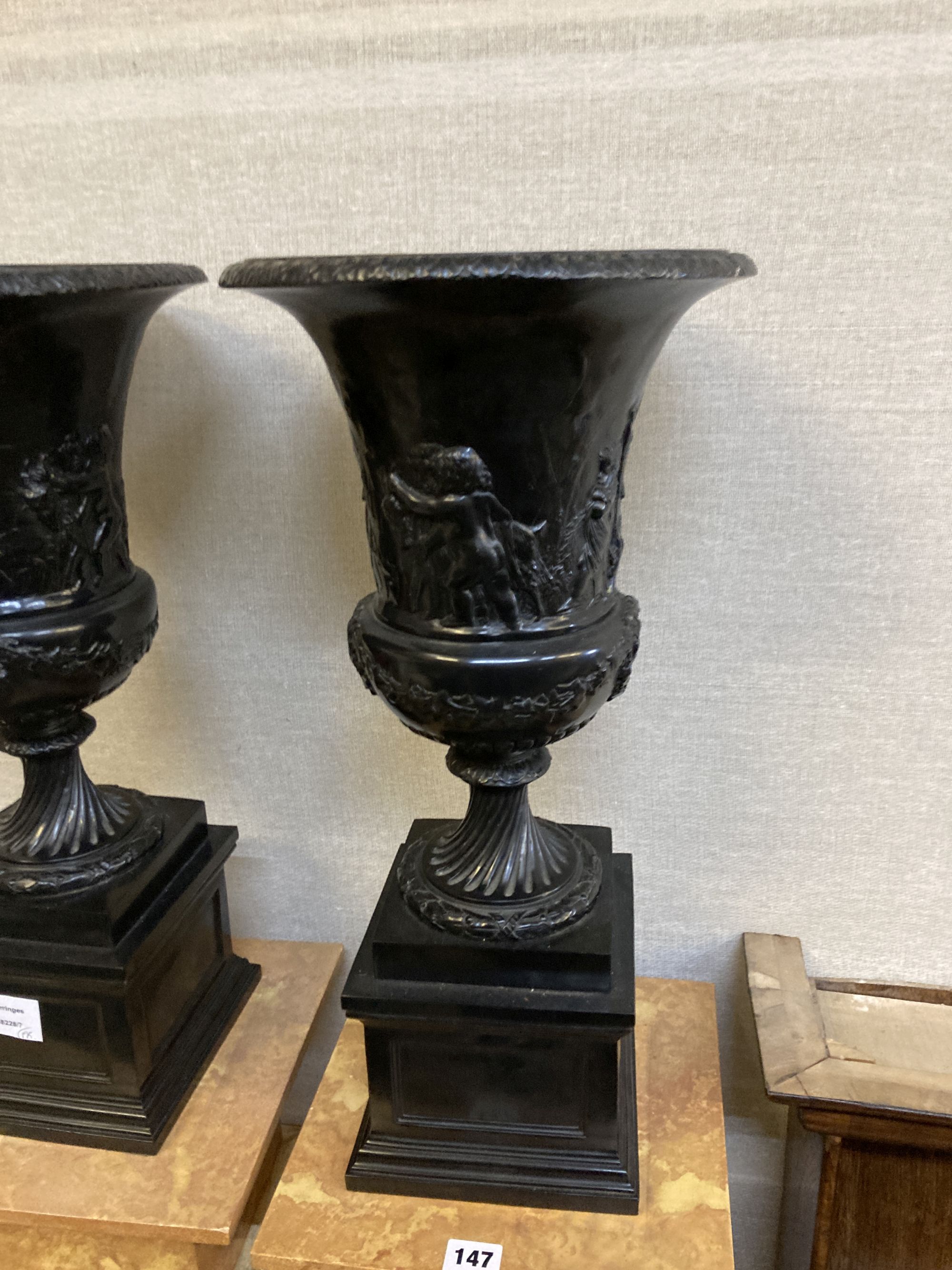 A pair of reproduction neoclassical composition pedestals and campana shaped urns, height 164cm